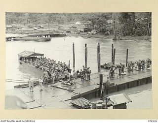 MILFORD HAVEN, LAE, NEW GUINEA. 1944-10-06. TROOPS OF THE 36TH INFANTRY BATTALION MOVING ALONG A FLOATING DOCK AND BOARDING AN AUSTRALIAN LANDING BARGE FOR TRANSPORT TO THE DUTCH TROOPSHIP, ..