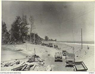 AITAPE, NEW GUINEA. 1944-12-26. THE CAMP AREA OF THE 2/14TH FIELD COMPANY, AND THE FLOOD DAMAGED APPROACHES TO THE BRIDGE ACROSS THE RIVER