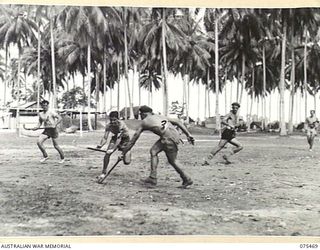 MILILAT, NEW GUINEA. 1944-08-23. AN EXCITING MOMENT DURING THE HOCKEY MATCH BETWEEN TEAMS FROM HEADQUARTERS, 5TH DIVISION AND THE HMAS "MANOORA"