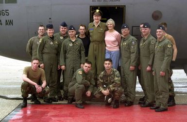 The crew of a US Air Force (USAF) C-130 Hercules from Yokota Air Base (AB), Japan, poses for a group photo after taking part in the first flight of the Christmas Drop from Andersen Air Force Base (AFB), Guam. Retired Colonel (COL) Gail Halvorsen, the Candy Bomber, is at center with his wife Lorraine