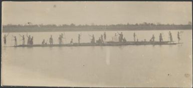 Twenty six men paddling a line of canoes, New Guinea, ca. 1935 / Sarah Chinnery