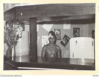 LAE AREA, NEW GUINEA. 1945-06-02. LUTU (1), BEHIND THE BAR AT A DANCE HELD AT THE SERGEANTS' MESS, HEADQUARTERS ANGAU, NORTHERN REGION (RESTRICTED)
