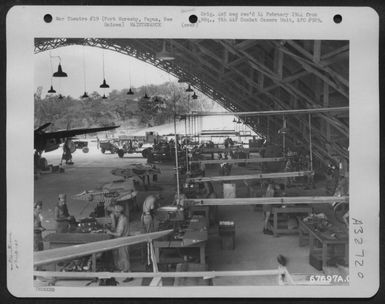 General View Of The 27Th Air Depot Group Sheet Metal Shop, Showing The Men At Work. The Shop Was Located In Hangar #1 At The Port Moresby Air Depot, Papua, New Guinea. 21 October 1943. (U.S. Air Force Number 67697AC)