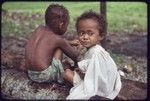 Children sitting on a log, Imala (r)