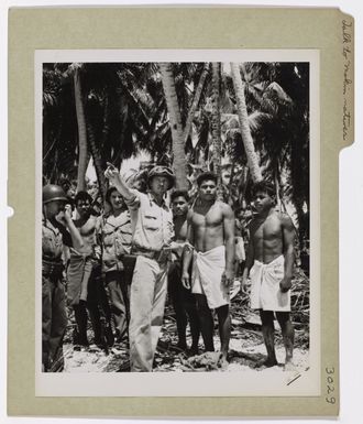 Coast Guardsmen Talk to Makin Natives