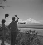 Tourists wave to Air France aircraft taking off at Papeete