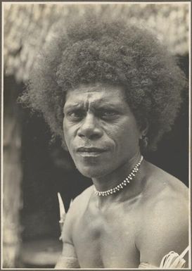 Men of Mailu [close up view of a man wearing a bead necklace] / Frank Hurley