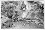 Men and boys standing outside the taualea, feasting shelter, after the ritual