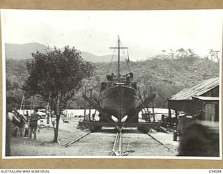 BALASANA, NEW GUINEA, 1943-07-06. NEW VESSEL NEARING COMPLETION ON THE SLIPWAYS OF THE 1ST AUSTRALIAN WATER TRANSPORT GROUP MAINTENANCE BASE