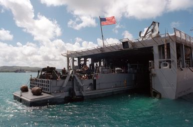 An US Navy (USN) Utility Landing Craft (LCU 1630) exits the well deck of the USS FORT MCHENRY (LSD 43) at the Sierra Pier, Guam during Exercise TANDEM THRUST 99