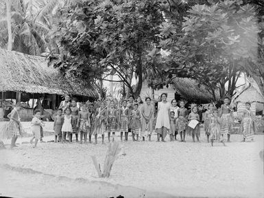 [Group portrait of children standing outside]