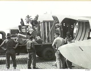 MILNE BAY, NEW GUINEA. 1944-04-06. TROOPS FROM 53RD DEPUTY COMMANDER, ROYAL AUSTRALIAN ENGINEERS (RAE) LOADING A DOUGLAS C47 DAKOTA TRANSPORT AIRCRAFT AT GURNEY'S AIR STRIP