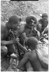 Men eating gwasu taro and coconut pudding