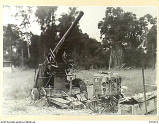 LAE BASE AREA, NEW GUINEA. 1944-12-27. A CAPTURED JAPANESE 75MM ANTI-AIRCRAFT GUN AND PREDICTOR EQUIPMENT AT THE 3RD CORPS SALVAGE UNIT