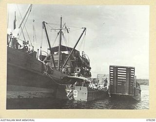 SIPAAI, BOUGAINVILLE ISLAND. 1945-01-07. TROOPS OF THE 31/51ST INFANTRY BATTALION UNLOADING UNIT STORES FROM THE AV1361 "POOLTA" INTO LANDING BARGES OF THE 42ND LANDING CRAFT COMPANY