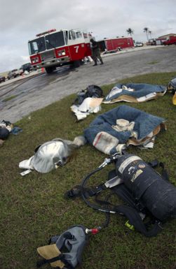 Firefighting equipment are strewn on the grass after U.S. Air Force Airmen from the 36th Civil Engineer Squadron responded to a minor explosion in a warehouse at Andersen Air Force Base, Guam, on Jan. 12, 2005. (USAF PHOTO by TECH. SGT. Cecilio Ricardo) (Released)