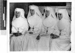 Four Catholic Nuns sitting in a row, Solomon Islands, Oceania, February 1, 1943