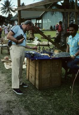 Tourist at black coral carvers stall, Nuku'alofa, June 1984