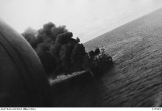 AT SEA. 1943-03-03. A JAPANESE TRANSPORT ON FIRE DURING THE BISMARCK SEA BATTLE, PHOTOGRAPHED FROM A BEAUFIGHTER OF NO. 30 SQUADRON RAAF, PILOTED BY 260353 FLIGHT LIEUTENANT R. F. UREN. (FILM STILL)