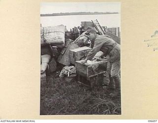 KAIRIRU ISLAND, NEW GUINEA. 1945-09-17. FOLLOWING THE SURRENDER JAPANESE NAVAL PERSONNEL WERE TRANSFERRED FROM KAIRIRU TO MUSCHU ISLAND. AS WELL AS PERSONAL GEAR MANY HAD FOWLS AND CHICKENS IN ..