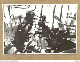 DONADABU AREA, NEW GUINEA. 1943-12-01. GUNNER OF THE NO. 3 GUN, A TROOP, NO. 7 BATTERY, 2/4TH AUSTRALIAN FIELD REGIMENT TAKING THINGS EASY DURING A LULL IN THE SHOOTING AT THE COMBINED EXERCISE ..