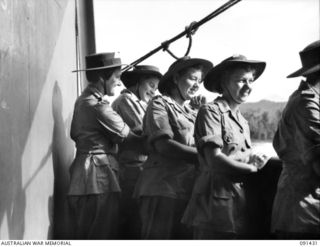 LAE, NEW GUINEA, 1945-05-07. AWAS PERSONNEL LOOKING OVER THE RAIL OF THE MV DUNTROON ANCHORED OFF MILFORD HAVEN. THEY ARE PART OF A GROUP OF 342 AWAS FROM AUSTRALIA EN ROUTE TO THE AWAS BARRACKS AT ..