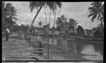 Houses and walkway on stilts at Baimuru (Vaimuru) village, Gulf Province