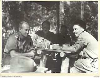 SAMPUN, NEW BRITAIN. 1945-01-14. AUSTRALIAN ARMY OFFICERS HOLDING A CONFERENCE AT THE BATTALION HEADQUARTERS OF THE 14/32ND INFANTRY BATTALION. IDENTIFIED PERSONNEL ARE:- NX92 LIEUTENANT-COLONEL ..