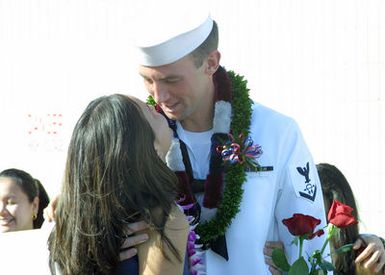 US Navy (USN) Sonar Technician Third Class (Surface Warfare) (ST3(SW)) Ellis greets his girlfriend at Pearl Harbor, Hawaii (HI). ST3(SW) Ellis arrived home on board his ship, the USN Arleigh Burke Class Guided Missile Destroyer, USS PAUL HAMILTON (DDG 60) after a deployment spanning more than nine months for Operation IRAQI FREEDOM