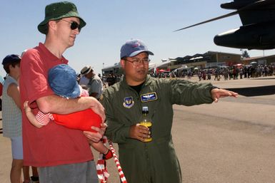 US Air Force (USAF) MASTER Sergeant (MSGT) Mark A. Muna, from Mangilao, Guam, an Aeromedical Technician, with the 86th Aeromedical Evacuation Squadron (AES), Ramstein Air Base (AB), Germany, explains the mission and capabilities of the C-9 Nightingale Aeromedical aircraft to a visitor at the African Aerospace Defense Exhibition and Air Show at Air Force Base (AFB) Waterkloof, South Africa