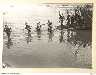 JABA RIVER AREA, BOUGAINVILLE, SOLOMON ISLANDS. 1944-12-18. B COMPANY, 15 INFANTRY BATTALION TROOPS LANDING BY BARGE ON THE SOUTH BANK OF THE RIVER TO TAKE UP NEW POSITIONS IN THE PERIMETER. ..