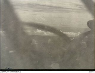 BISMARCK ARCHIPELAGO. 1944-03-28. PART OF NEW BRITAIN AS SEEN FROM A BEAUFIGHTER AIRCRAFT OF NO. 30 SQUADRON RAAF FLOWN BY FLIGHT SERGEANT T. BOEHM OF SA, AS ESCORT AIRCRAFT, OF NO. 79 (SPITFIRE) ..