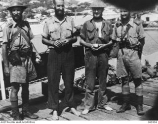 Port Moresby, New Guinea. 1942-04-12. The four officers of Lark Force of the Rabaul Garrison, photographed on the jetty in front of the HMAS Laurabada, the ship which evacuated 156 survivors from ..