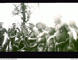 THE SOLOMON ISLANDS, 1945. AUSTRALIAN SOLDIERS AND NATIVE PORTERS ON THE NUMA NUMA TRAIL ON BOUGAINVILLE ISLAND. (RNZAF OFFICIAL PHOTOGRAPH.)