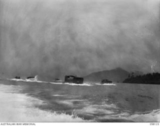 SALAMAUA, NEW GUINEA, 1943-09-26. A CONVOY OF AMERICAN ARMY BARGES PASSING THE PENINSULA ON THEIR WAY TO LAE