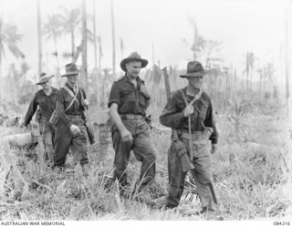 SUAIN PLANTATION, NEW GUINEA. 1944-12-06. LIEUTENANT-COLONEL N.W.P. FARRELL, COMMANDING OFFICER, 2/4 INFANTRY BATTALION (2), RETURNING WITH HIS MEN AFTER A DAY'S PATROLLING OF THE DANMAP RIVER AREA ..