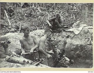 BOUGAINVILLE. 1945-04-18. A MORTAR CREW FROM 6 DETACHMENT SECTION, HEADQUARTERS COMPANY, 24 INFANTRY BATTALION IN ACTION, SUPPORTING THE INFANTRY ADVANCE DURING THE ATTACK SOUTH OF HATAI-BUIN ROAD ..