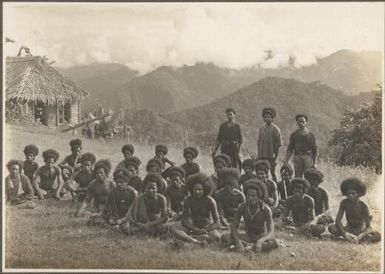 Views around Dilava [group of men with a hut in background] Frank Hurley
