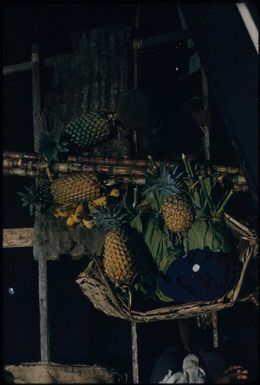 Selling pineapples from a canoe (seen from trawler above) : New Britain coastline, Papua New Guinea, 1960 / Terence and Margaret Spencer