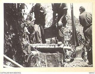 JABA RIVER AREA, BOUGAINVILLE, SOLOMON ISLANDS. 1944-12-18. D COMPANY, 15 INFANTRY BATTALION TROOPS CARRYING STORES AND AMMUNITION FROM A BARGE AT THE SOUTH BANK OF THE RIVER DURING THEIR MOVEMENT ..