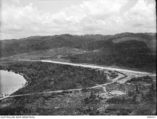 WEWAK AIRSTRIP, NEW GUINEA, 1945-09-12. AERIAL VIEW OF WEWAK AIRSTRIP. THIS WAS SECURED ON 1945-05-10 AS A RESULT OF THE ADVANCE OF 19 INFANTRY BRIGADE TOWARDS THE FOOTHILLS SOUTH OF THE AIRSTRIP. ..