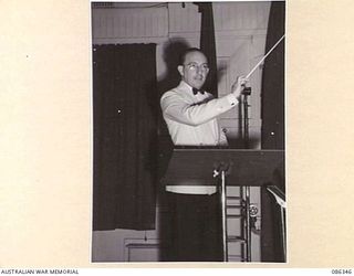 MELBOURNE, VIC. 1945-01-06. MR CHAS TAYLOR CONDUCTING THE 3AW BROADCASTING STUDIO ORCHESTRA. HE SAW SERVICE AS A FLYING OFFICER WITH THE RAAF IN NEW GUINEA