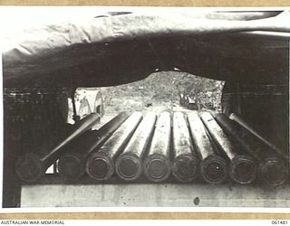 PORT MORESBY, NEW GUINEA. 1943-12-07. 25-POUNDER GUN BARRELS IN STORAGE, RESTING ON A CONCRETE BLOCK WITH A CANOPY OVER THE TOP AT NO. 3 SUB DEPOT, 10TH AUSTRALIAN ADVANCED ORDNANCE DEPOT