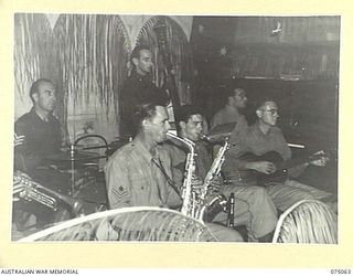 LAE, NEW GUINEA. 1944-08-09. THE DIGGER DANDEES DANCE BAND PLAYING DURING THE DANCE ORGANISED BY THE OTHER RANKS OF THE LAE BASE SUB AREA FOR PERSONNEL OF THE 2/7TH AUSTRALIAN GENERAL HOSPITAL, THE ..