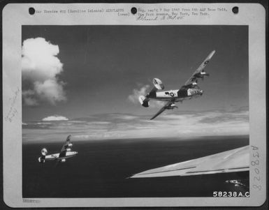 Consolidated B-24 Bombers Peeling Off For Landing After Having Bombed Anti-Aircraft Positions On Korror Island, Palau Group, Caroline Island. 1 May 1945. (U.S. Air Force Number 58238AC)