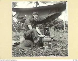 SINGORKAI - WEBER POINT AREA, NEW GUINEA, 1944-03-21. V37345 SIGNALMAN W. S. ABSALOM, A MEMBER OF THE PAPUAN INFANTRY BATTALION COMMUNICATED WITH A PATROL TWENTY MILES AWAY USING A 108 MKIII ..