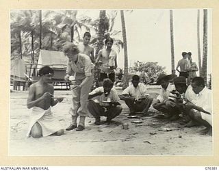 LAE, NEW GUINEA. 1944-09-29. INDIAN TROOPS, EX-PRISONERS OF WAR OF THE JAPANESE, ENJOYING A MEAL AT A PICNIC ARRANGED FOR THEM BY THE AUSTRALIAN RED CROSS SOCIETY