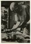 Portrait of artist Len Annois at work, 1960