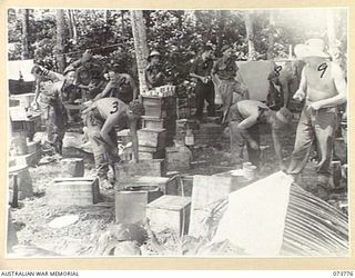 KARKAR ISLAND, NEW GUINEA. 1944-06-02. MEMBERS OF THE 37/52ND INFANTRY BATTALION OPEN CASES TO ASSIST THE DISTRIBUTION OF RATIONS TO COMPANIES. THE DISTRIBUTION IS BEING ARRANGED BY NO 4 PLATOON, ..