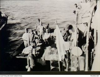 Simpson Bay, Rabaul, New Britain. 6 September 1945. The Japanese surrender party including General H. Imamura, Commander Eight Army Area, Admiral J. Kusaka, Commander South East Area Fleet stand on ..